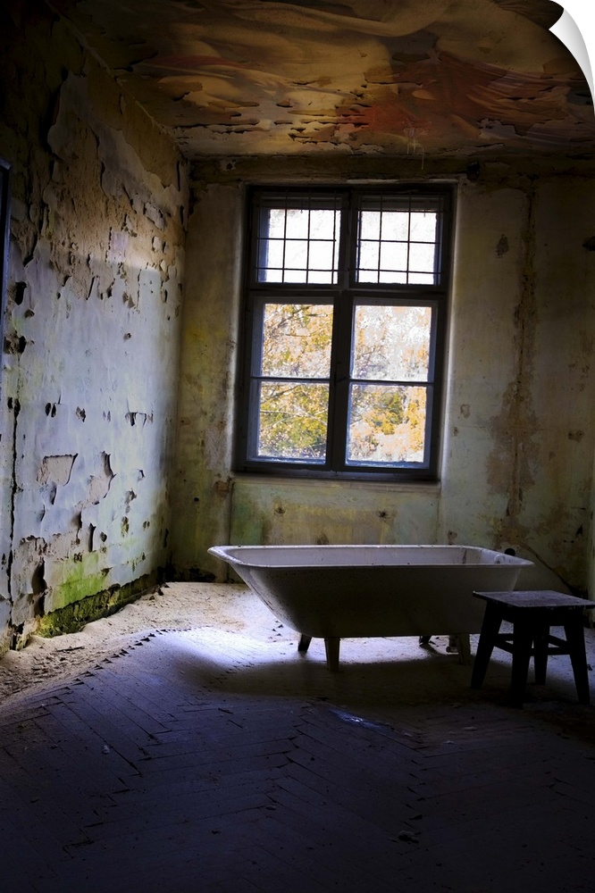 Old bathroom with stool in derelict room near window