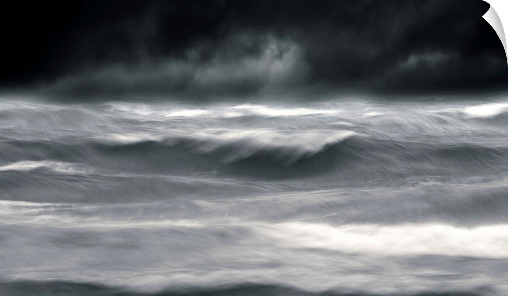 Powerful waves in a seascape under a dark stormy sky