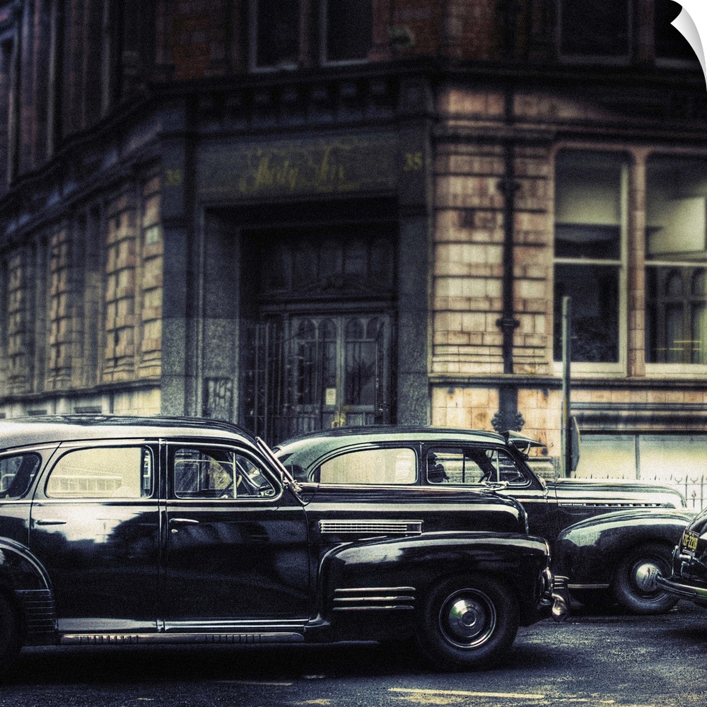 A 1941 cadillac series-61 and a 1941 chevrolet master deluxe sedan parked in the street with full period look