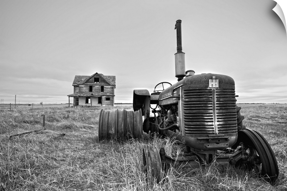Derelict farm machinery with house in Pierce County USA