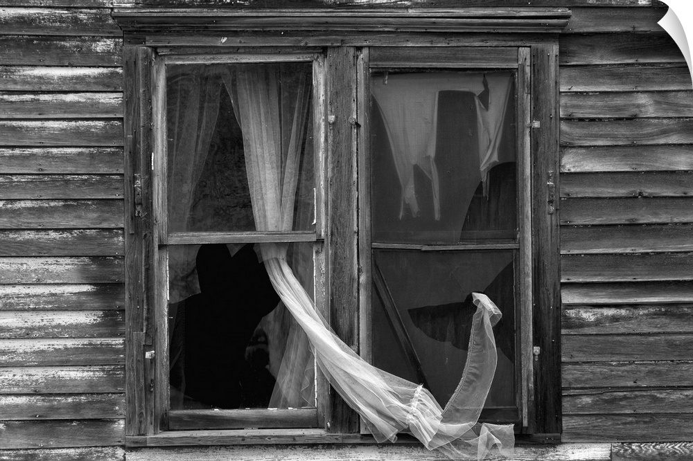 Abandoned house with curtain in broken window in Berwick, McHenry County USA