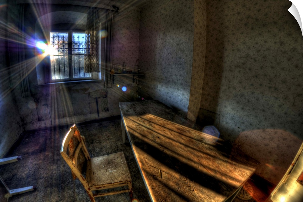 Abandoned room interior with chair and desk and sunlight from behind
