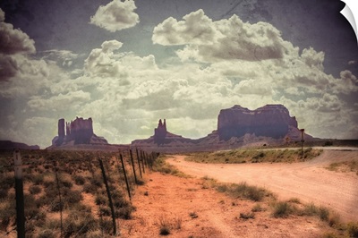 Large monolithic rocks in the background looking through Monument Valley III