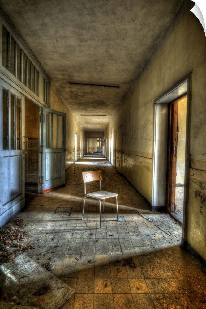 Interior of decaying old tanks barracks somewhere near Berlin with chair in corridor and sunlight