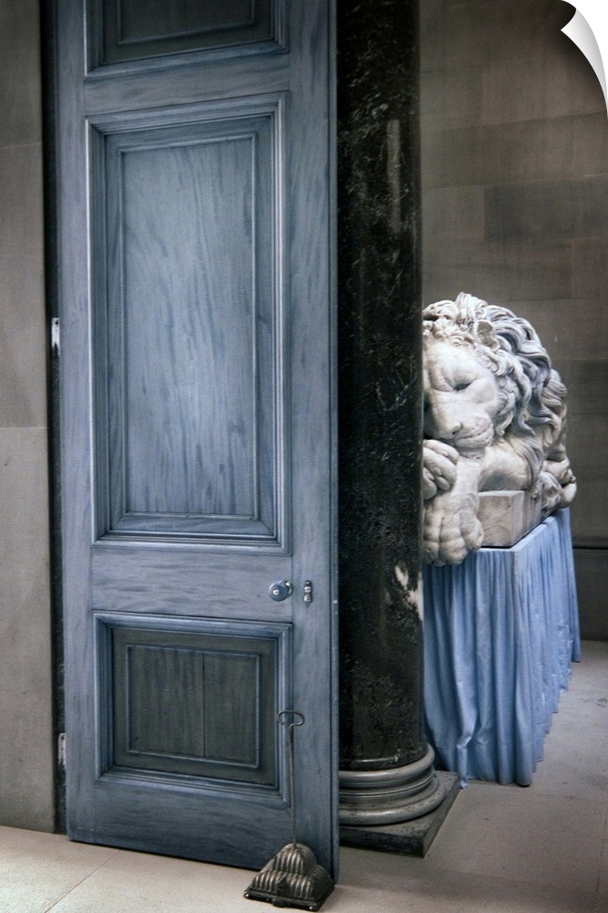 A large door and a carved marble lion