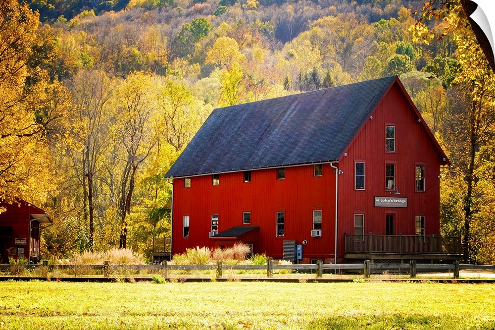 Typical red barn surrounded by vibrant autumn foliage. Kent, Connecticut.