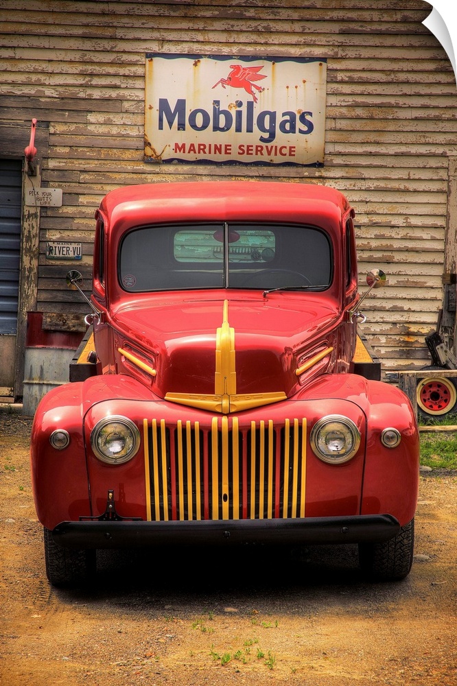 Classic old red truck parked in front of a Mobilgas sign.