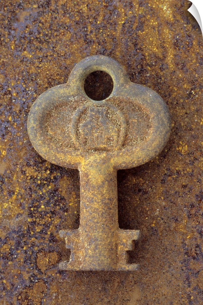 Small stubby old rusty key lying on metal sheet covered in identically coloured rust