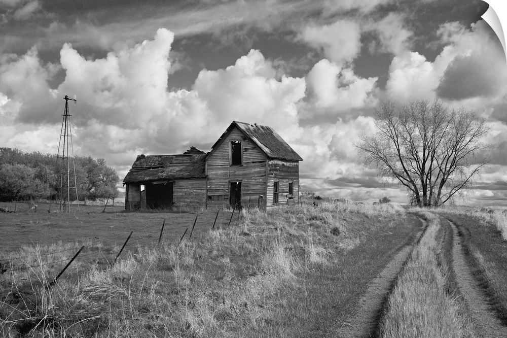 rural scene with old barn and farm track under cloudy sky in Rolette County USA