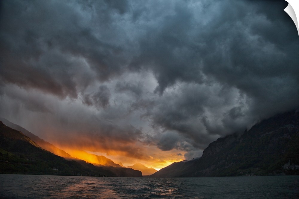 Glowing sunrise/sunset with stormy sky over mountains