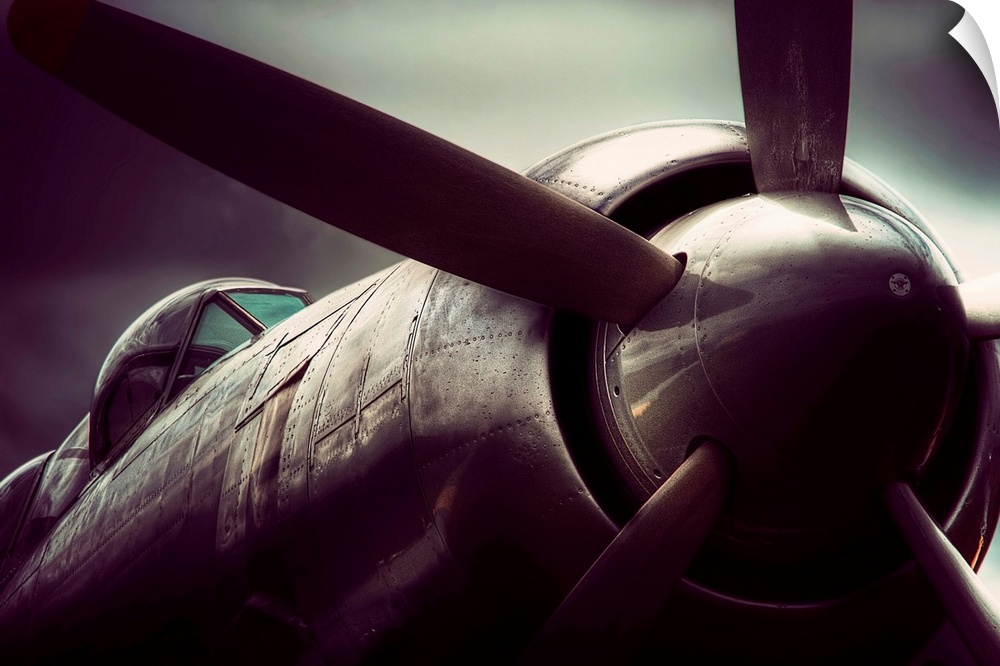 Big, horizontal, close up, fine art photograph of a SeaFury T20, showing the propeller and cockpit, against a blurred back...