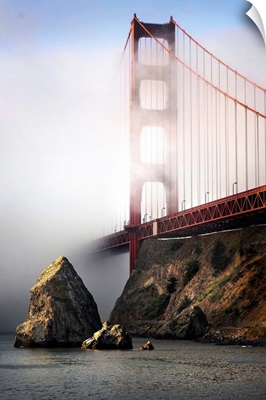 The Golden Gate bridge shrouded in mist at sunrise