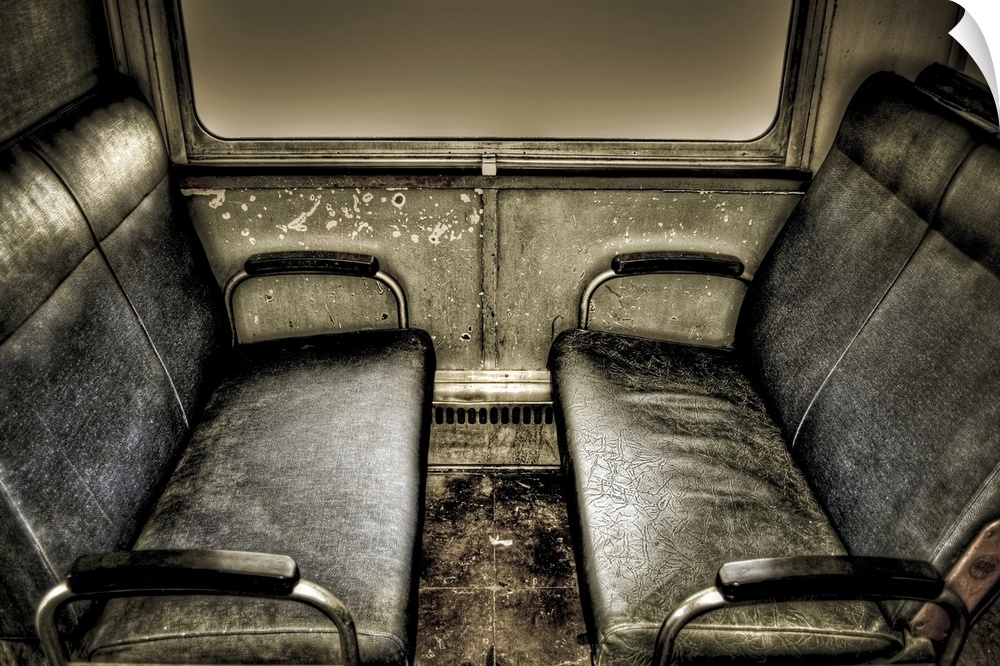 Interior of old train carriage with black seats