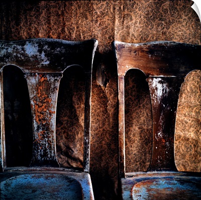 Two old chairs against a wall