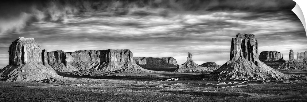 Black and white panoramic view of rock formations in Monument Valley, Utah.