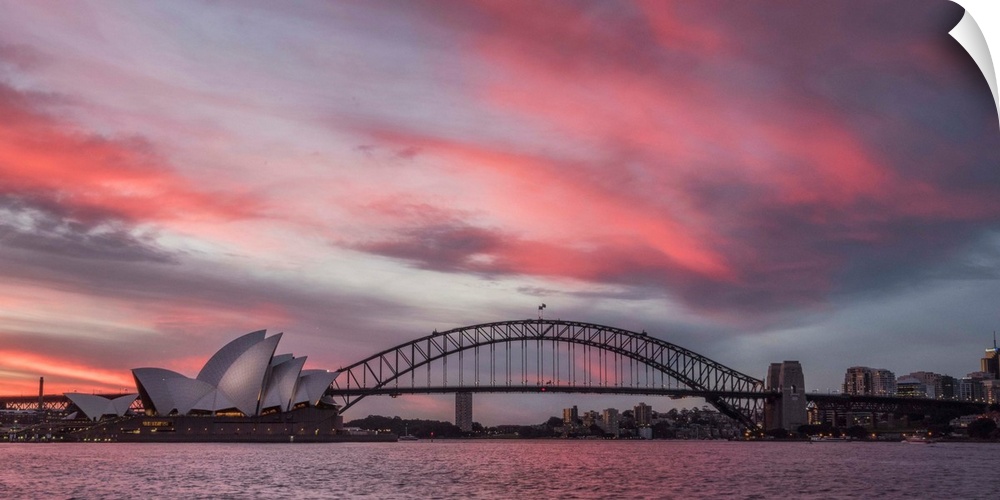 Panoramic photograph of the Harbor Bridge in Sydney, Australia at sunset.