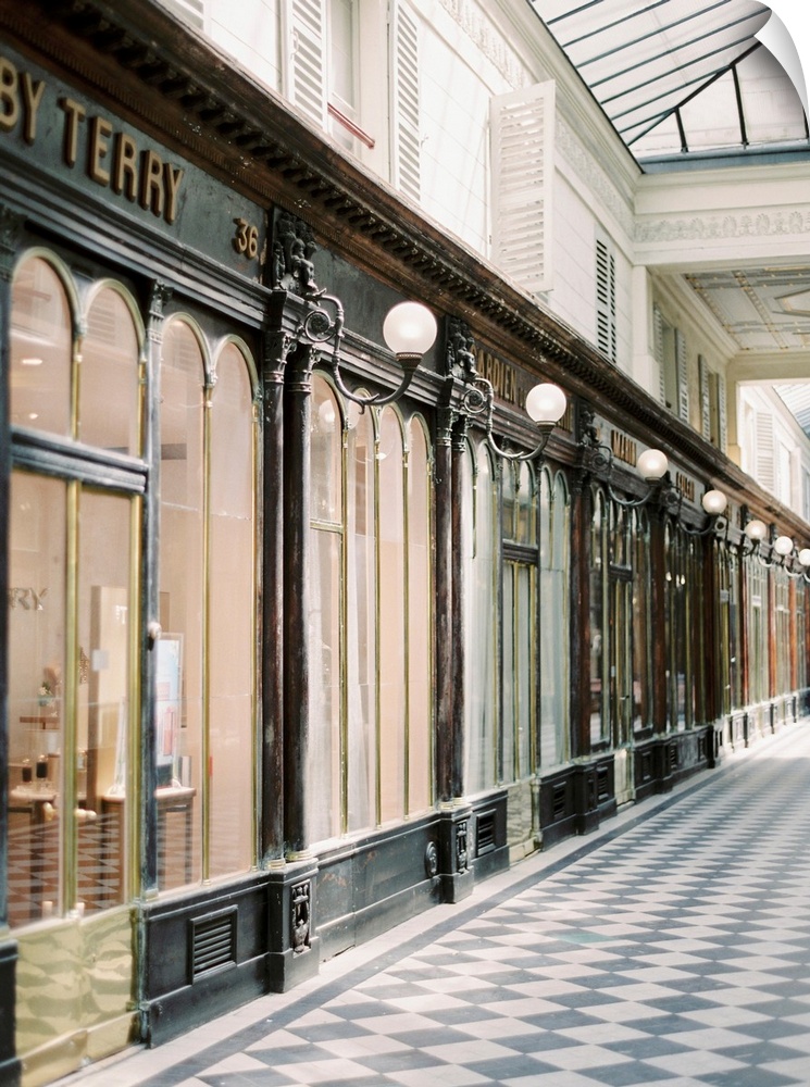 A photograph of an arcade of stores in an elegant shopping district of Paris, France.
