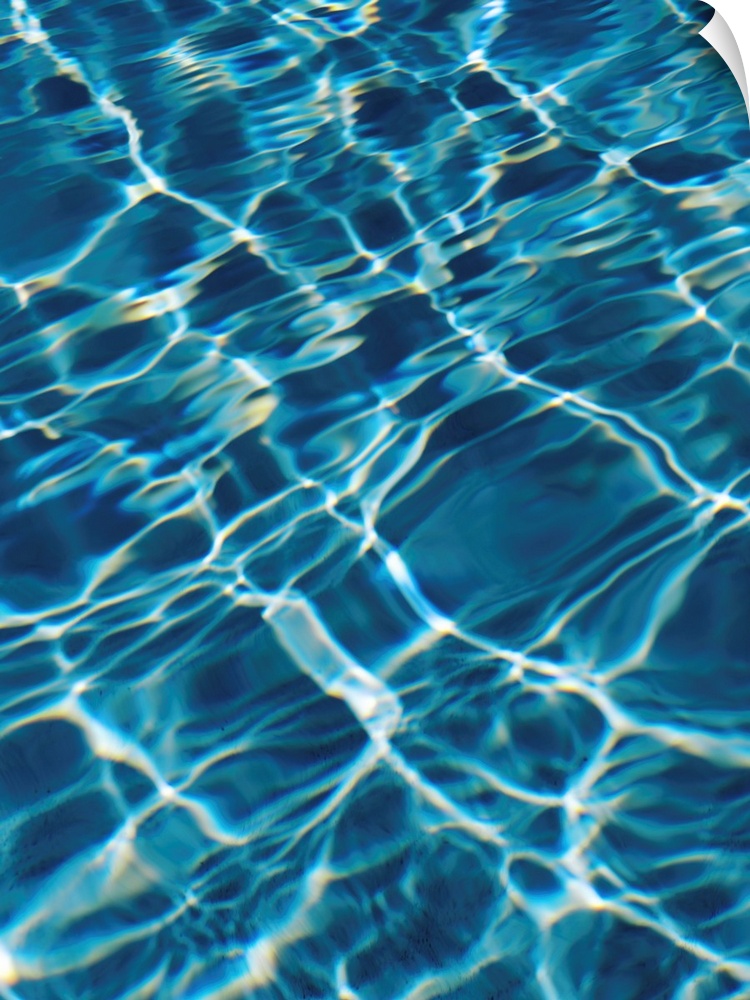 An abstracted photograph of sunlight reflecting off of clear pool water.