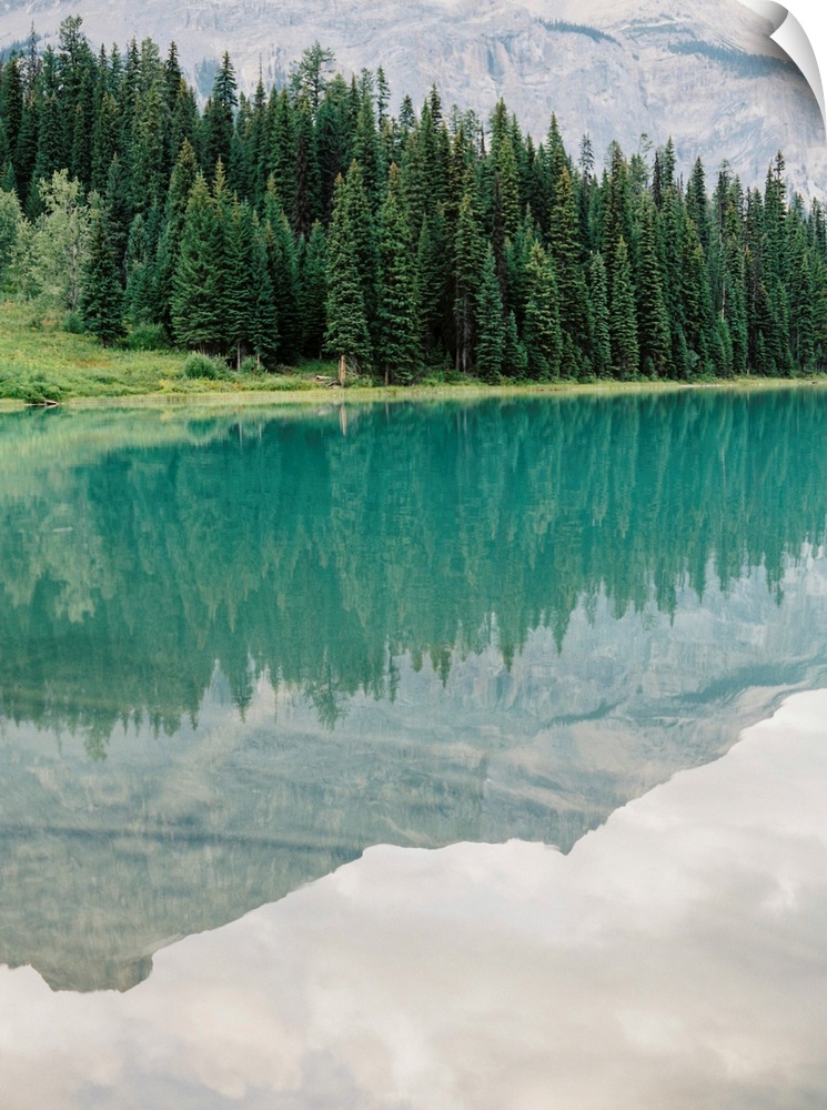 Photograph of mountains reflected in the glassy surface of Moraine Lake, Emerald Lake Lodge, Banff, Canada.