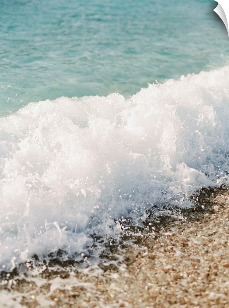 Photograph of a small wave breaking on a sandy beach, Corfu, Greece.