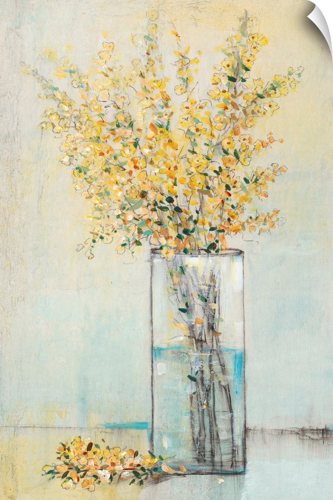 Yellow flowers sitting in a rectangular glass vase.