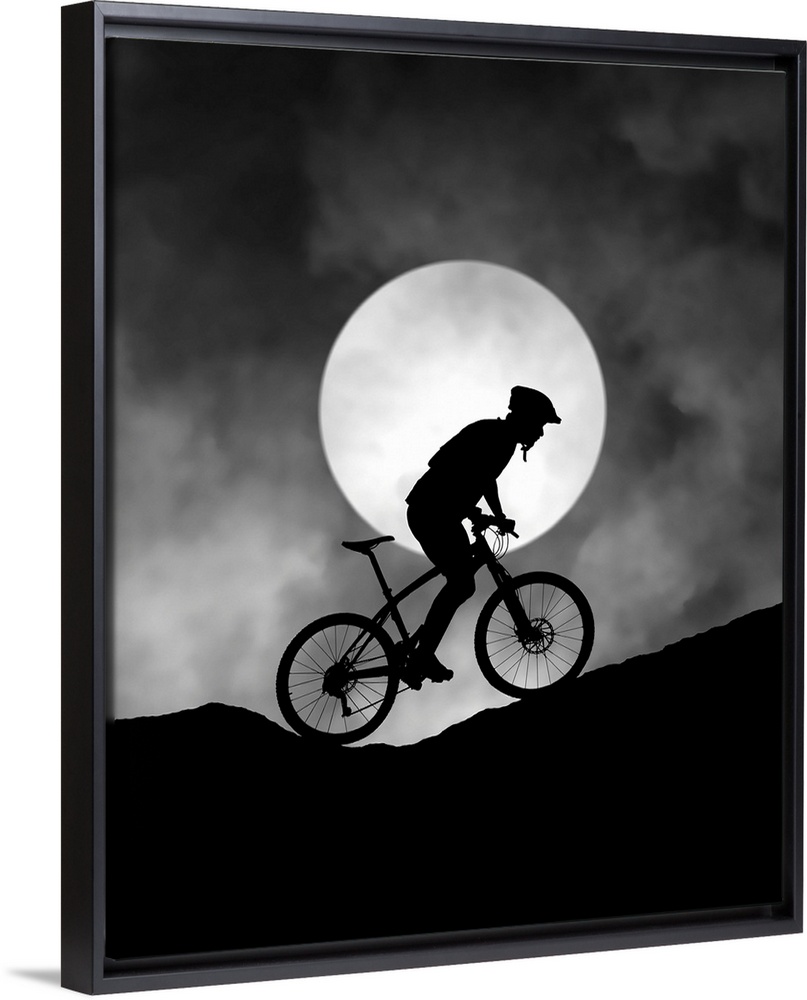 Silhouette of a biker pedaling up a hill, with the moon low in the sky.