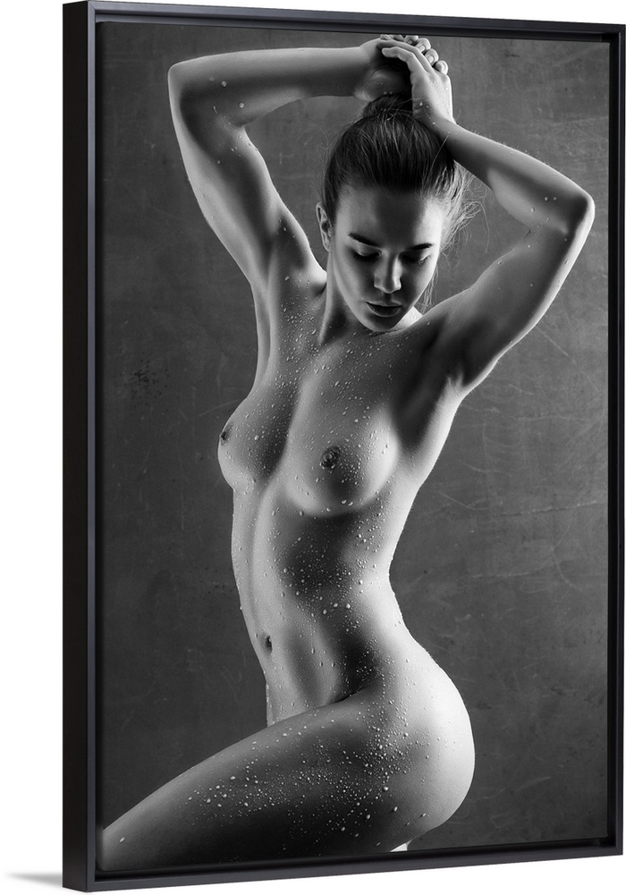 Elegant black and white fine art photograph of a nude woman posing with water drops all over her body.