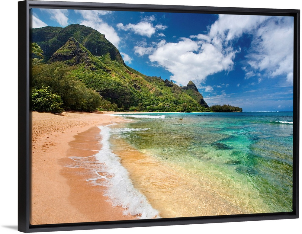 Big photograph shows the clear waters of the Pacific Ocean slowly making their way to the sandy shores of an island.  In t...