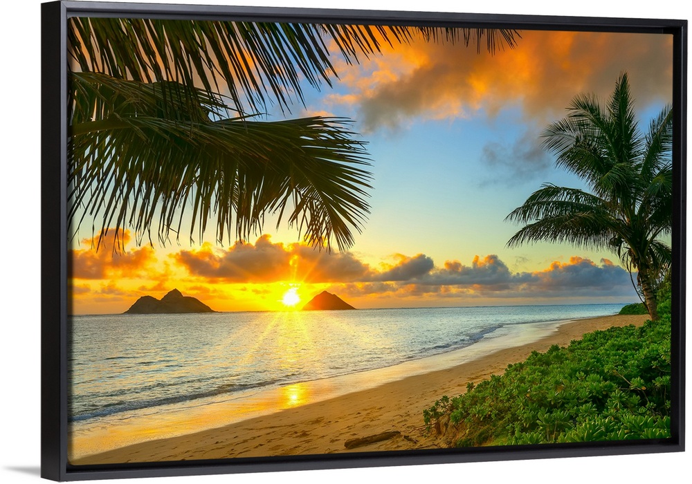 Sunrise viewed from Lanikai Beach with a view of the Mokulua Islands off the coast; Oahu, Hawaii, United States of America.
