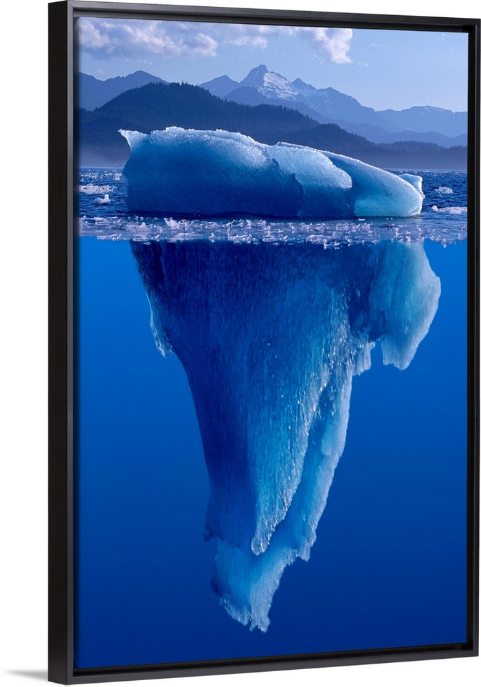 A composite photograph of a large Iceberg as seen from under and above the water.