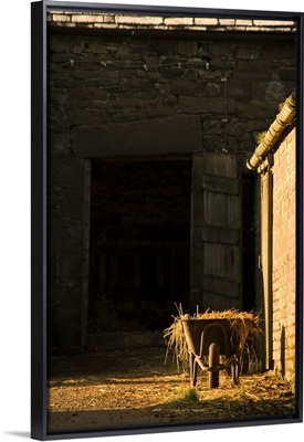 Wheelbarrow Beside A Barn
