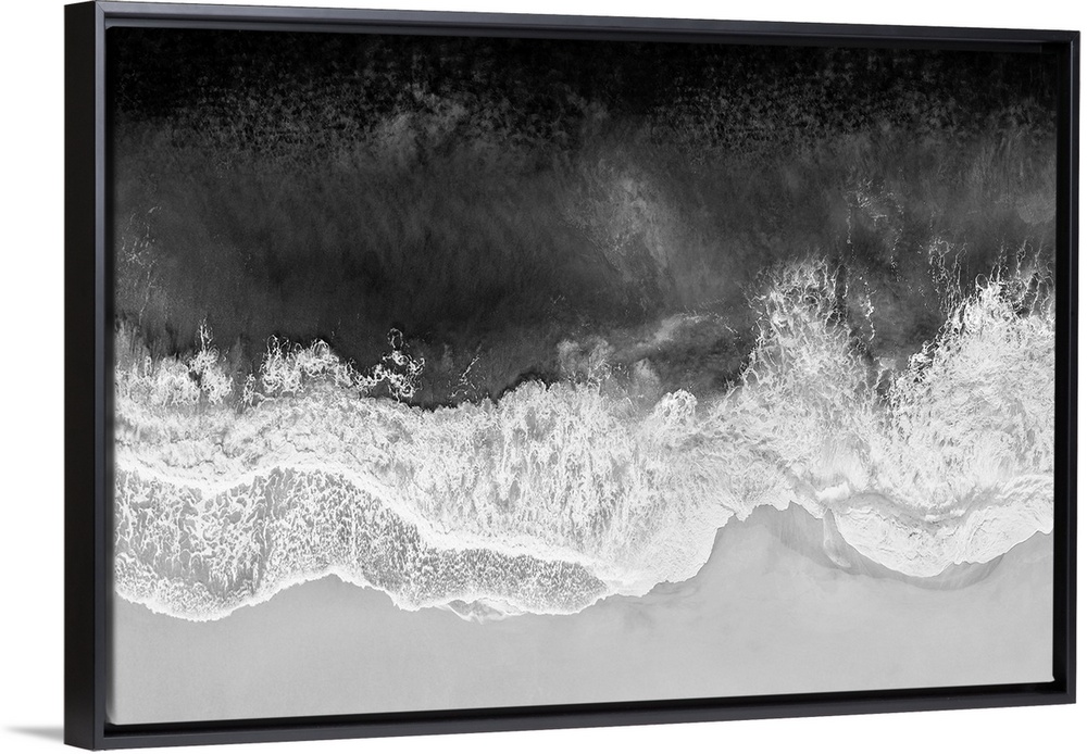 One artwork in a series of aerial shots of a beach as dark gray waves break upon the shore.