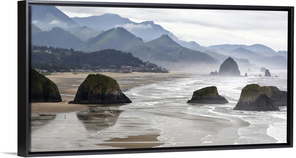 USA, Oregon, Cannon Beach. Fog rises over coastline at low tide.