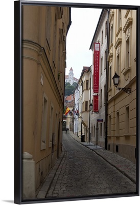 Slovakia, Bratislava. Narrow street with view of Bratislava Castle in distance