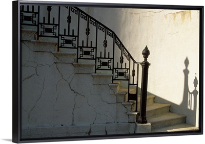 Wrought iron railing and steps with shadow detail