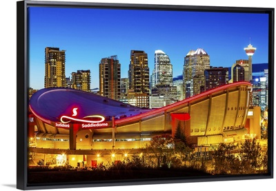 Canada, Alberta, Calgary, Skyline of downtown Calgary and Saddledome illuminated at dusk