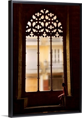 Spain, Valencia, Hall of Lonja de La Seda, Woman sitting by a window