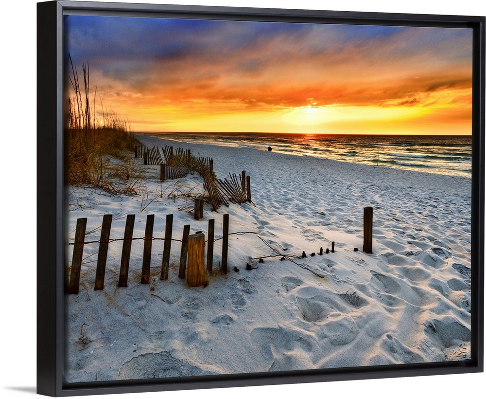 A sandy beach before a bright red sunset on the beach. The sand in This part of Florida is bright white. Landscape taken o...