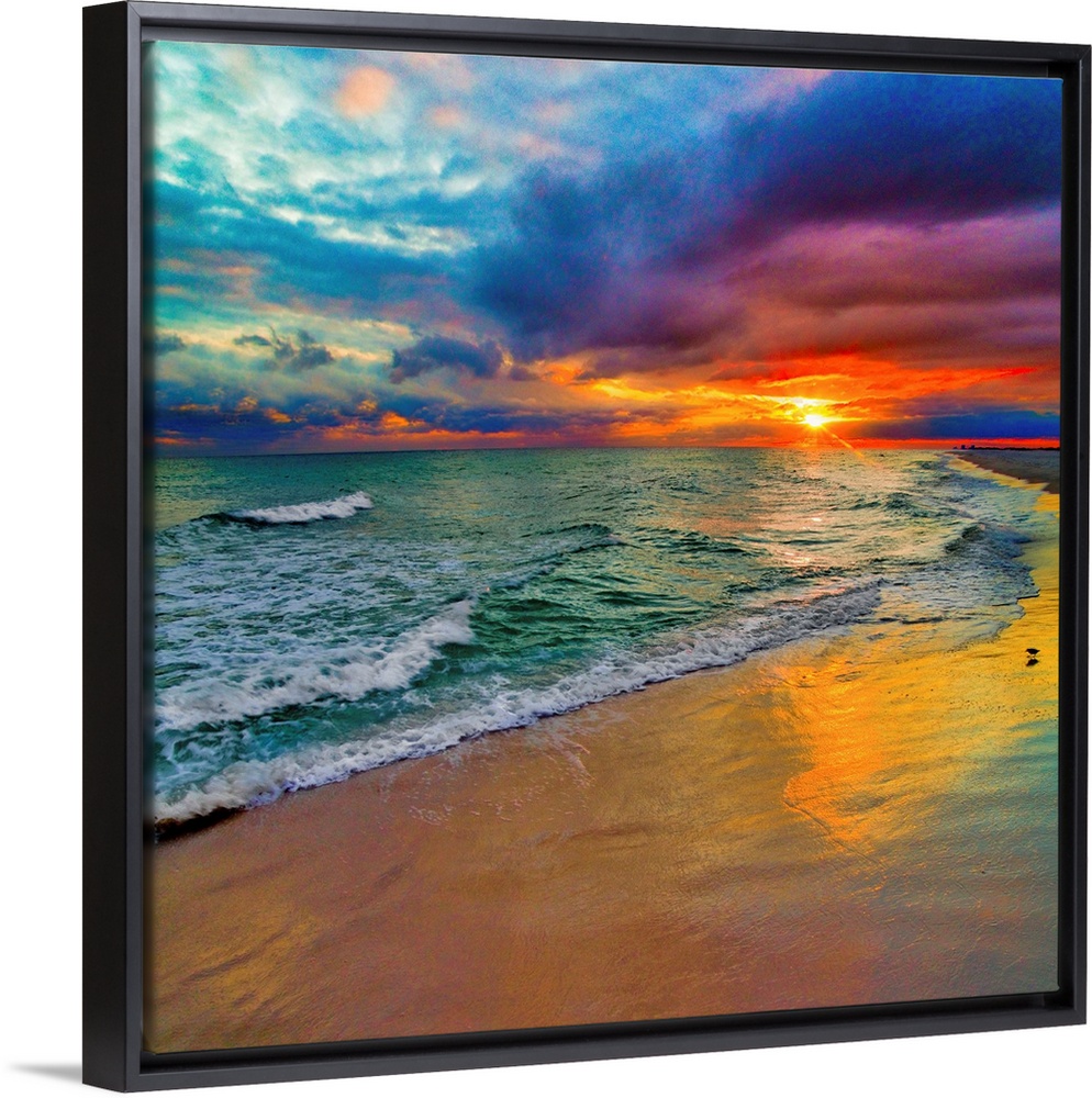 A square image of the sun descending over the ocean amid bright, technicolor clouds.