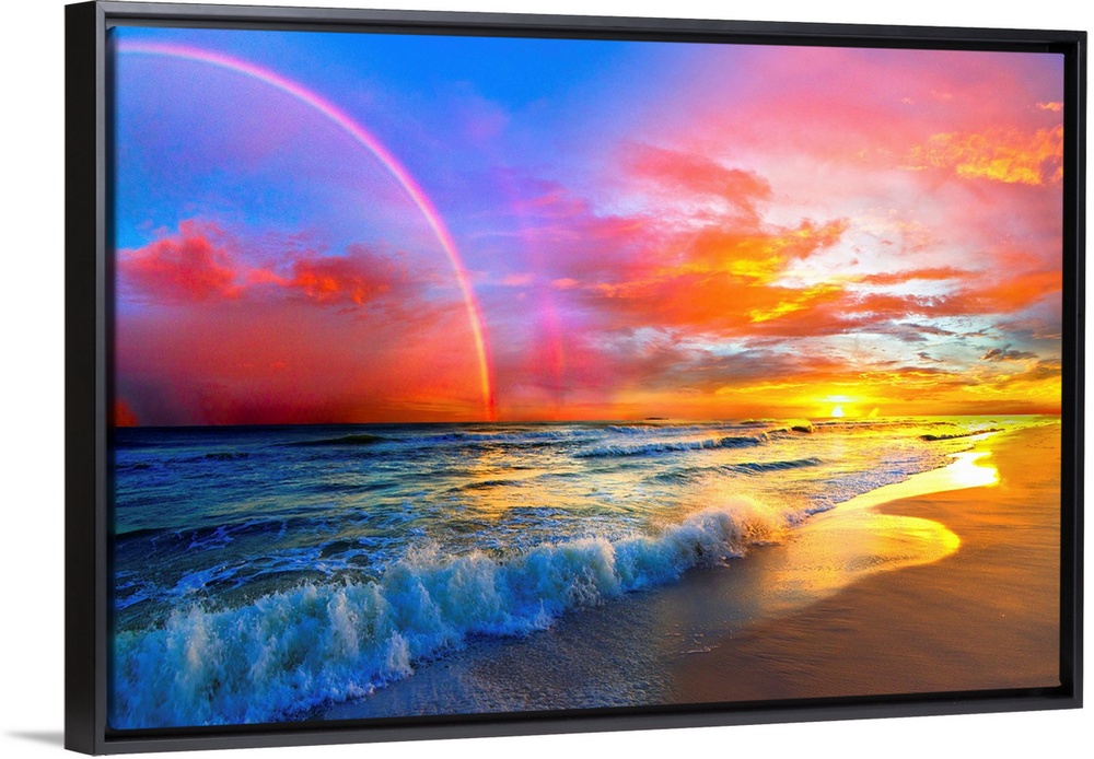 A beautiful colorful pink rainbow and sunset over ocean waves of a sandy beach. The colors and light of the beautiful suns...