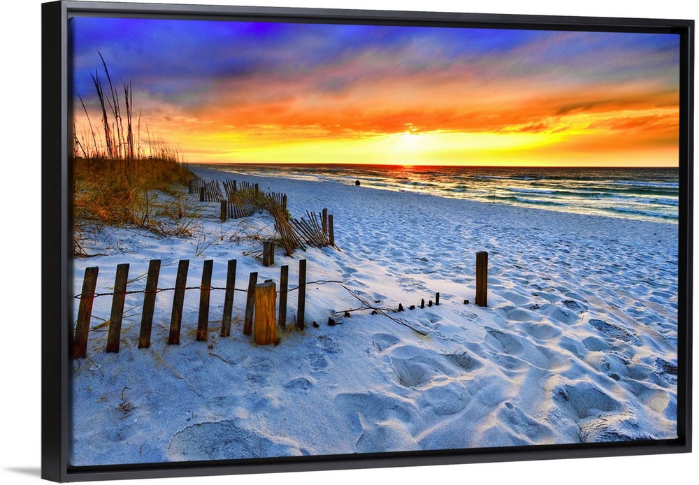 A dark burning red sunset on the beach in this beautiful landscape. A burning sun sets in the distant sea beyond a sandy s...