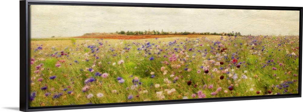 A colorful field of painted wildflowers beneath a clear, open sky on a large, horizontal wall hanging.