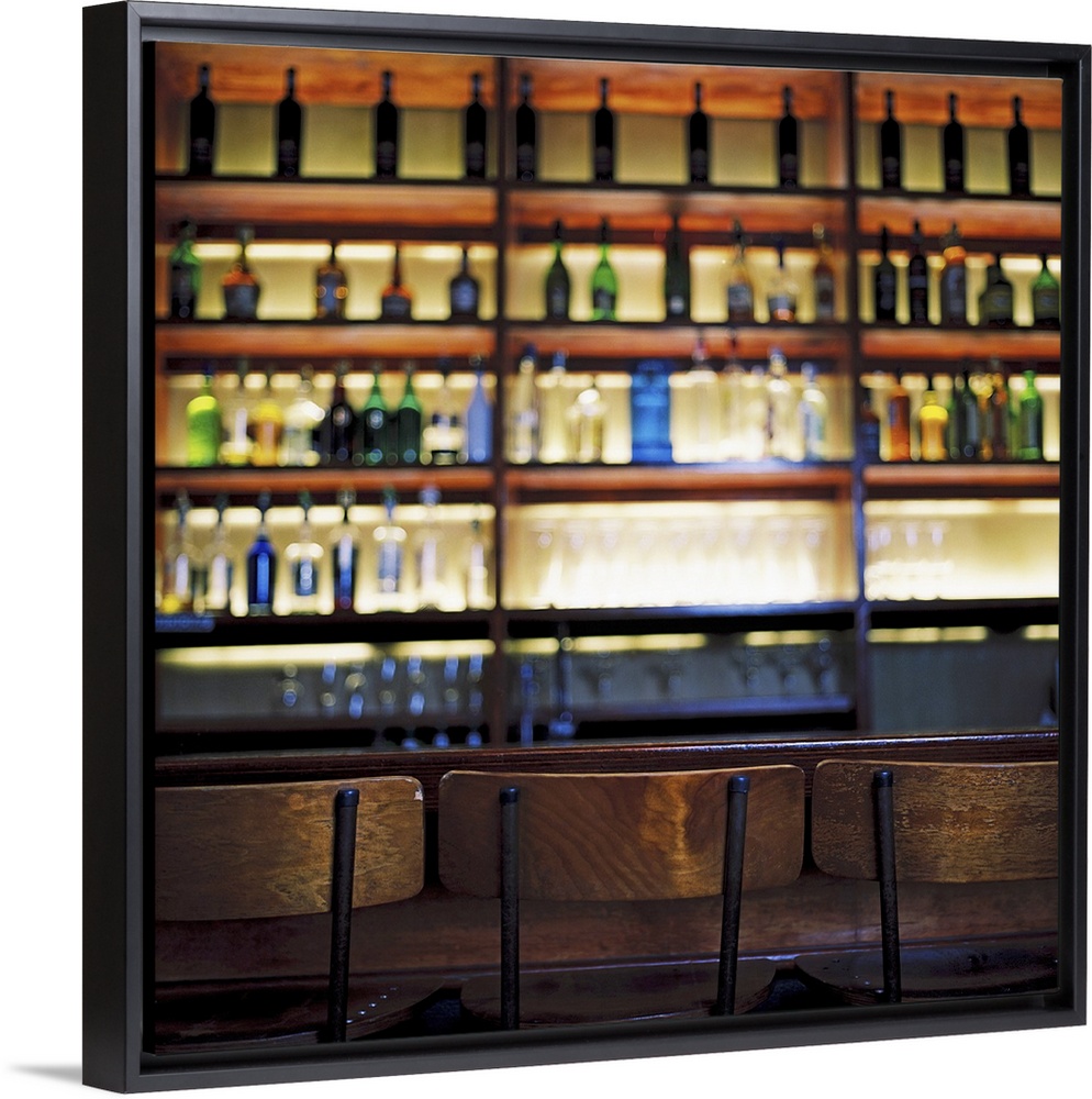 an array of bottles kept in shelves at a bar
