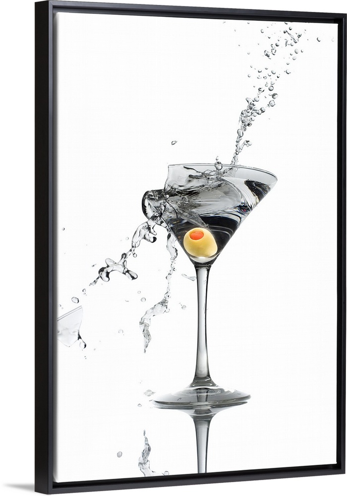 A shattering martini glass on a white background spraying liquid outward.