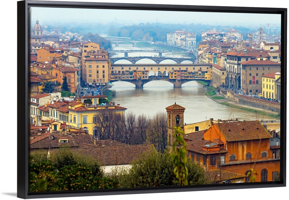 Giant photograph overlooking the Fiume Arno surrounded by a busy city within Italy.  On the shores of the river, the build...