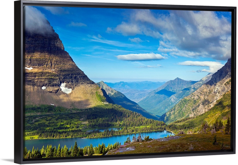 Large, landscape photograph of  Hidden Lake from an overlook, surrounded by mountains in Glacier National Park.