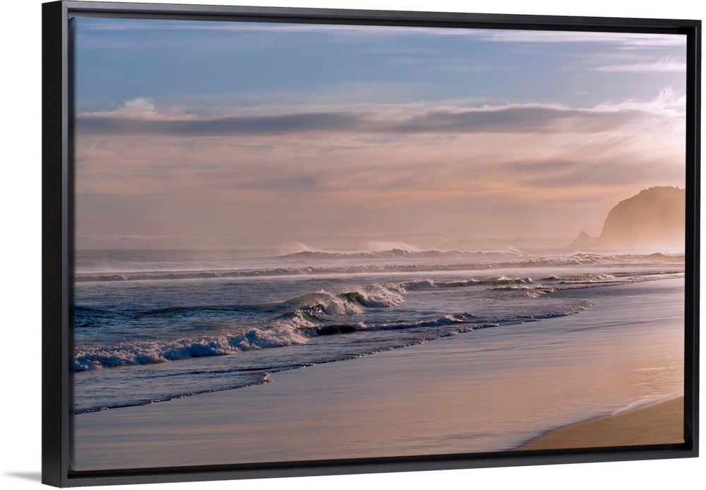 Horizontal photograph on large canvas of waves crashing into the shoreline at St. Kilda, Dunedin.  The sun is setting and ...