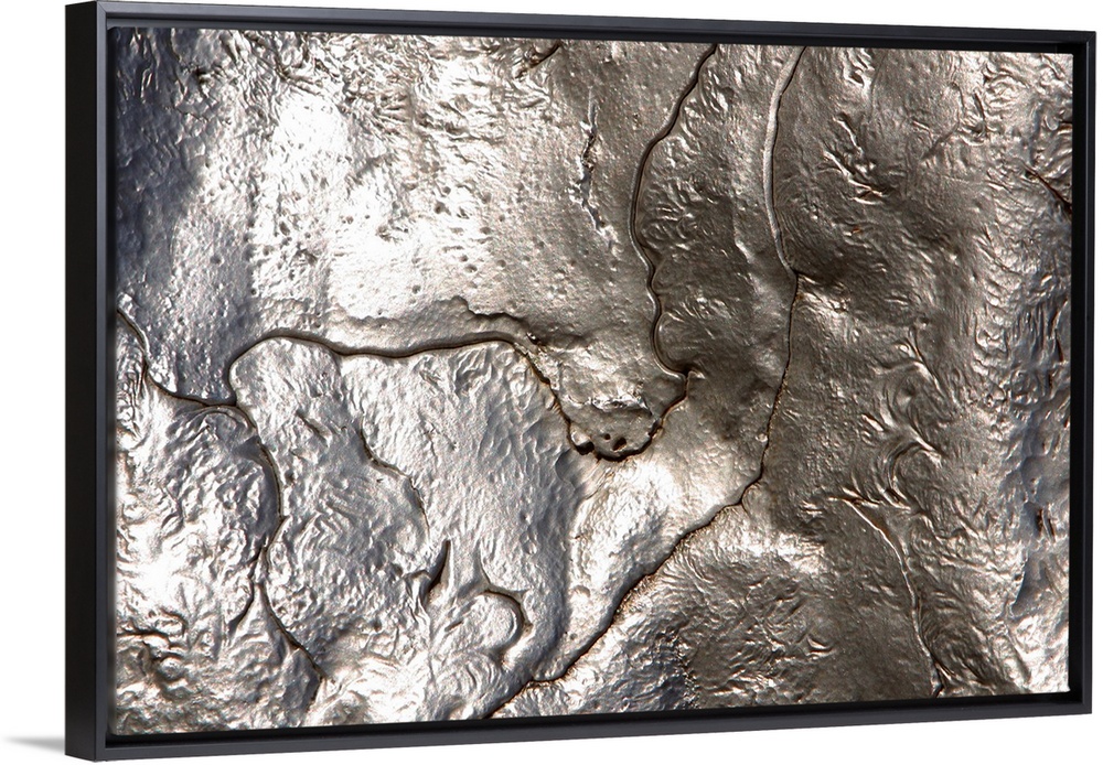 Abstract artwork of a metallic silver object that has been photographed close up.