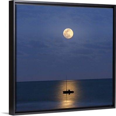 Silhouette sailboat with moon