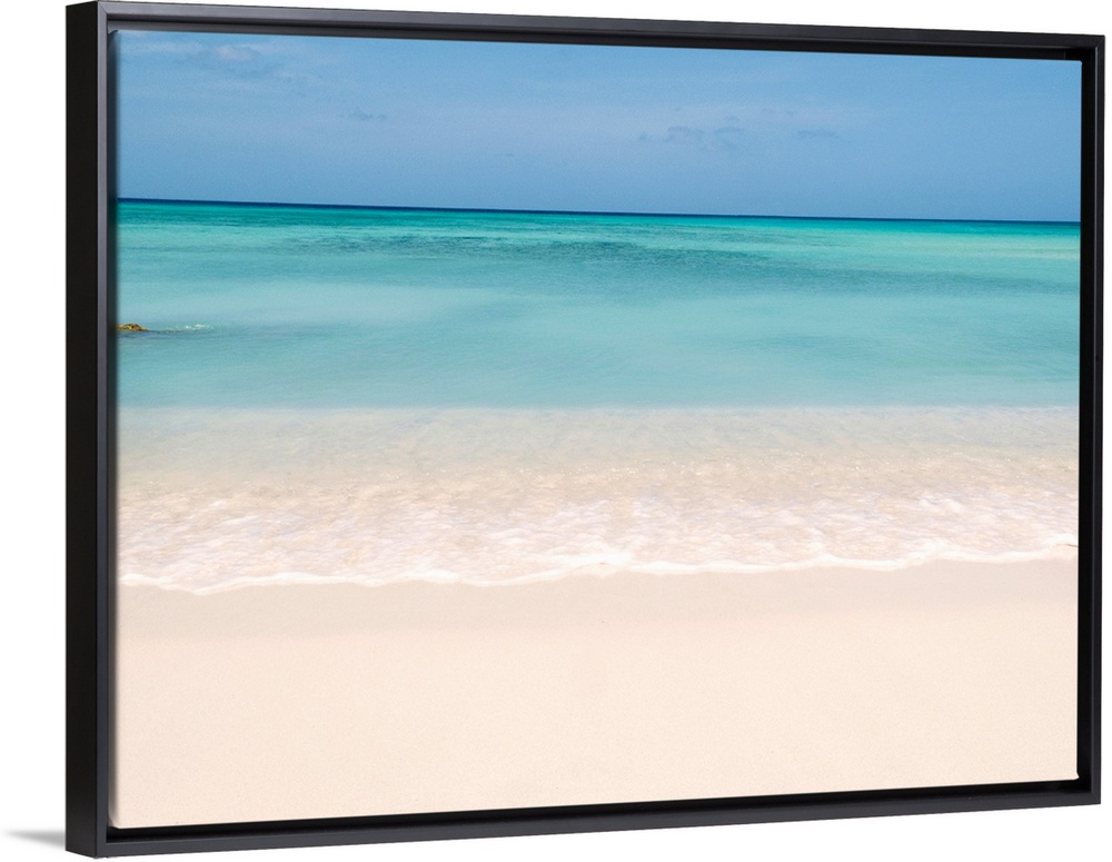 Horiztonal wall art of a serene beach and a still sea on a clear day in Aruba.